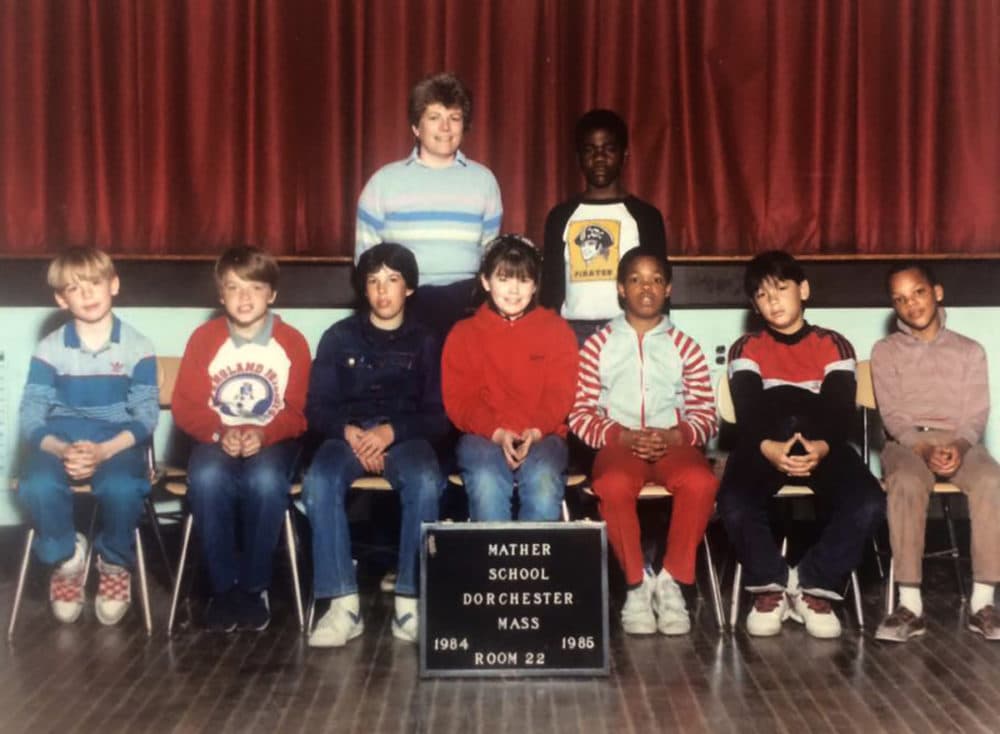 Eight children and their teacher pose as a group in a school auditorium. O'Toole is the only girl.