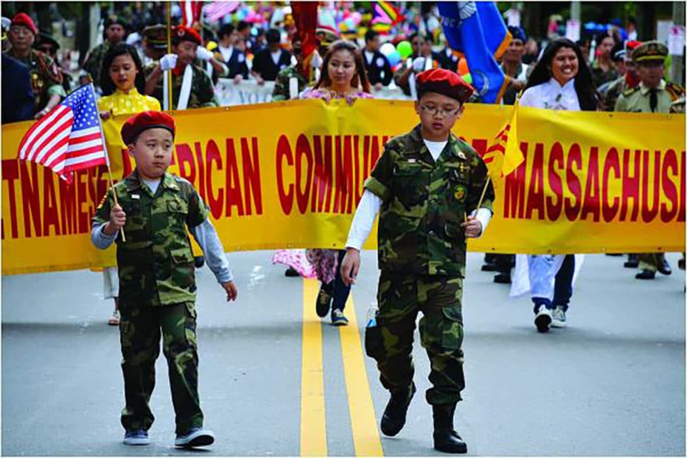 Two boys in uniform led a contingent of marchers representing the Vietnamese-American Community of Massachusetts in the Dorchester Day Parade last year. (Chris Lovett/Dorchester Reporter)