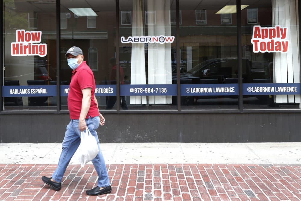 A man walks by a career center storefront on June 5 in Lawrence, Mass. (Elise Amendola/AP)