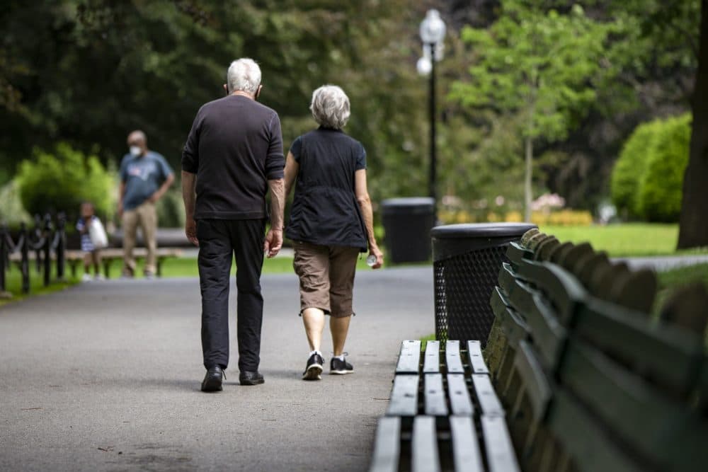 An older couple out for a walk through the Boston Public Garden. (Jesse Costa/WBUR)