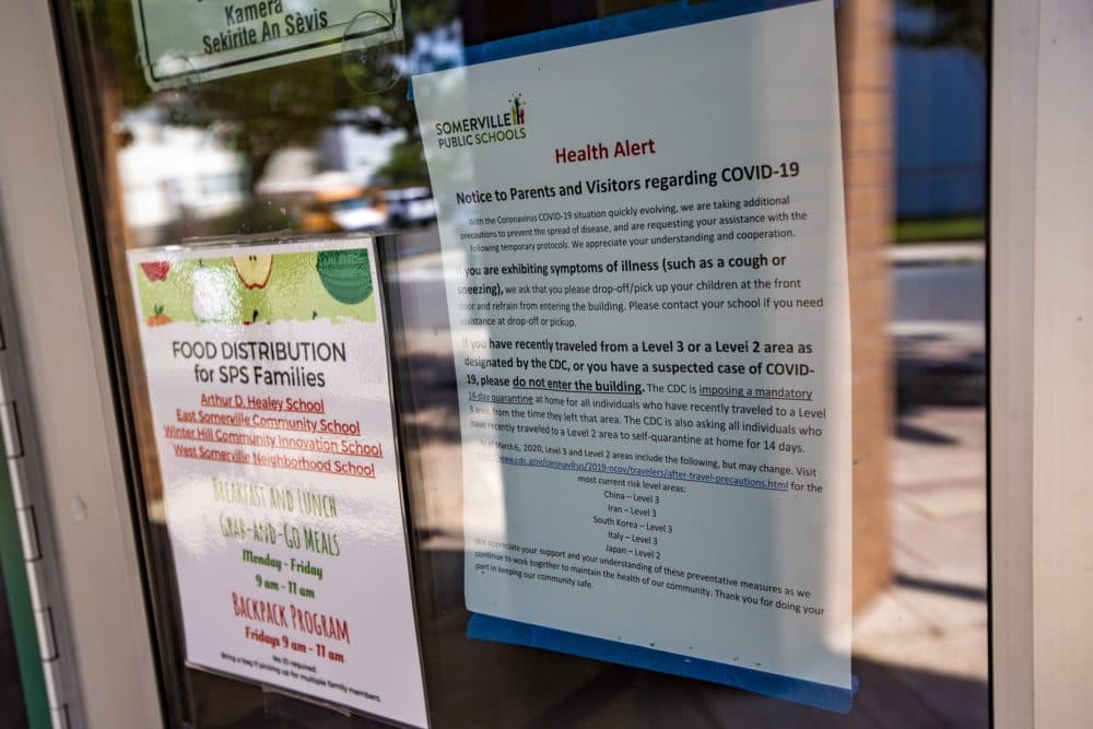 A health alert notice to parents and visitors regarding COVID-19 at the entrance of the Michael E. Capuano Early Education Center. (Jesse Costa/WBUR)