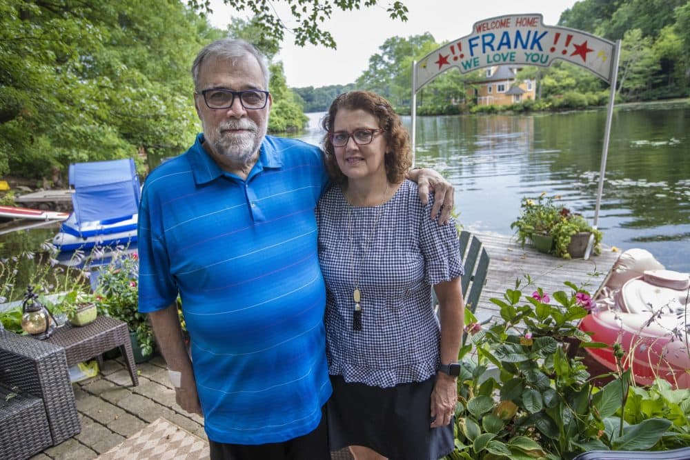 Frank and Leslie Cutitta at their home in Wayland where a banner still hangs for his return from the hospital. (Jesse Costa/WBUR)