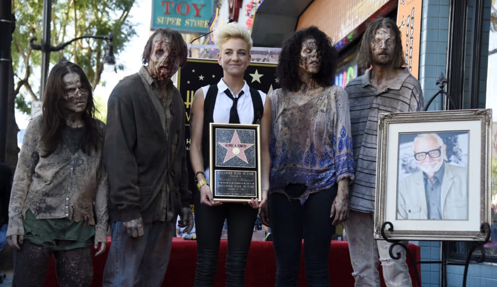 Tina Romero, center, daughter of the late director George A. Romero, poses with zombie characters following a ceremony honoring him with a star on the Hollywood Walk of Fame on Wednesday, Oct. 25, 2017, in Los Angeles. Romero, the writer/director of the 1968 film &quot;Night of the Living Dead&quot; died on July 16. (Photo by Chris Pizzello/Invision/AP)