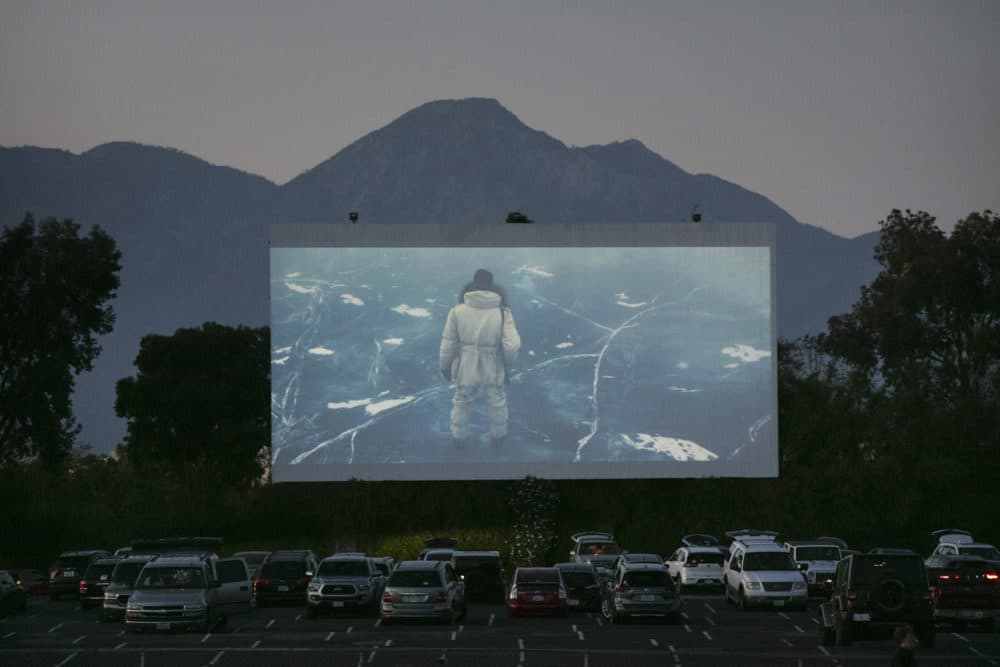 Moviegoers watch a preview in their socially distanced vehicles at Mission Tiki drive-in theater in Montclair, Calif., Thursday, May 28, 2020. California moved to further relax its coronavirus restrictions and help the battered economy. (Jae C. Hong/AP Photo)
