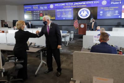 Vice President Mike Pence elbow bumps employees as he visits the state Emergency Operations Center in Baton Rouge, La., Tuesday, July 14, 2020. (Gerald Herbert/AP)