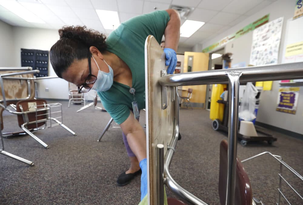 Josefina Median wears a mask as she cleans a classroom at Wylie High School Tuesday, July 14, 2020, in Wylie, Texas. (LM Otero/AP Photo)