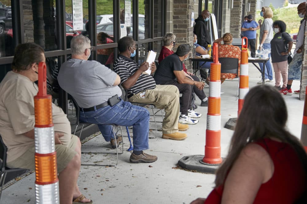 Job seekers exercise social distancing as they wait to be called into the Heartland Workforce Solutions office in Omaha, Neb., July 15, 2020. (Nati Harnik/AP)