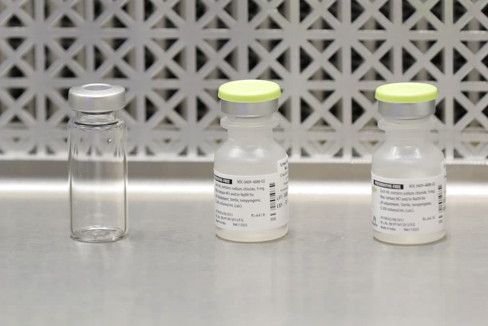 This March 16, 2020 file photo shows vials used by pharmacists to prepare syringes used on the first day of a first-stage safety study clinical trial of the potential vaccine for COVID-19, the disease caused by the new coronavirus, at the Kaiser Permanente Washington Health Research Institute in Seattle. (Ted S. Warren/AP File)