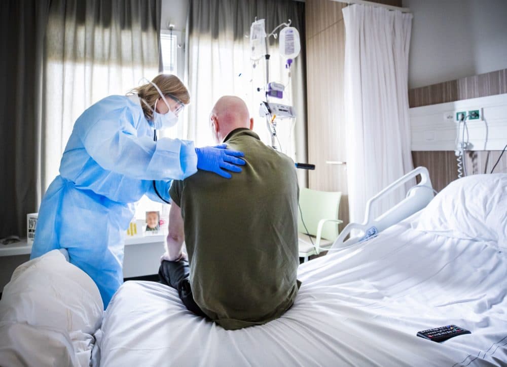 An attending physician listens to the breathing of a patient who is recovering after admission to an intensive care unit (ICU) in the coronavirus (COVID-19) patient nursing department of The HMC Westeinde Hospital in The Hague. (Remko De Waal/ANP/AFP via Getty Images)