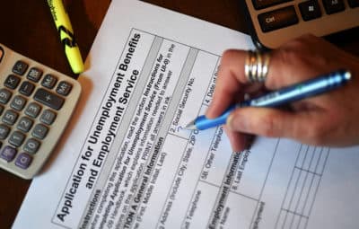 In this photo illustration, a person files an application for unemployment benefits on April 16, 2020, in Arlington, Virginia. (Olivier Douliery/AFP via Getty Images)