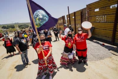 Members of the Kumeyaay band of Indians and demonstrators rally at the United States-Mexico border to protest construction of new wall being constructed on their ancestral grounds on July 1, 2020 in Boulevard, California.(SANDY HUFFAKER/AFP via Getty Images)