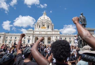 Supporters raise their fists while standing at the State Capitol during a National Mother's March in St. Paul, Minnesota July 12, 2020. (Amanda Sabga/AFP via Getty Images)