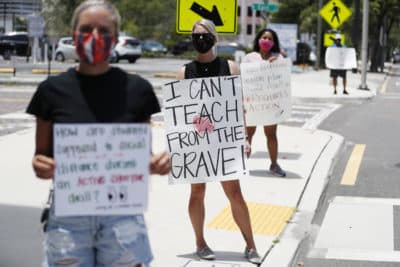 Middle school teacher Brittany Myers, (C) stands in protest in front of the Hillsborough County Schools District Office on July 16, 2020 in Tampa, Florida. (Octavio Jones/Getty Images)