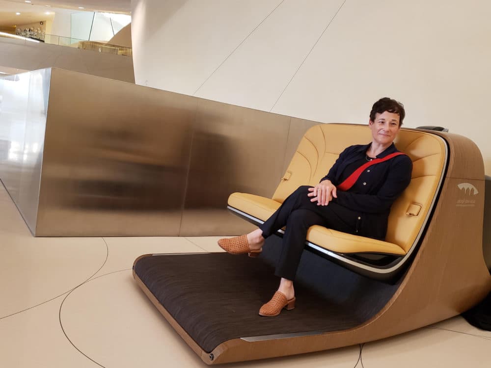 Sandy Goldberg sits in a special chair at the National Museum of Qatar, one of her many museum clients around the world. (Courtesy of Sandy Goldberg)