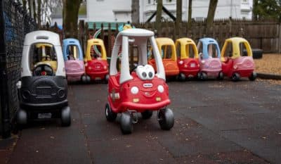 Children's vehicles parked at Waltham Day Care Center in March as providers closed as a precaution against the spread of COVID-19. (Robin Lubbock/WBUR)