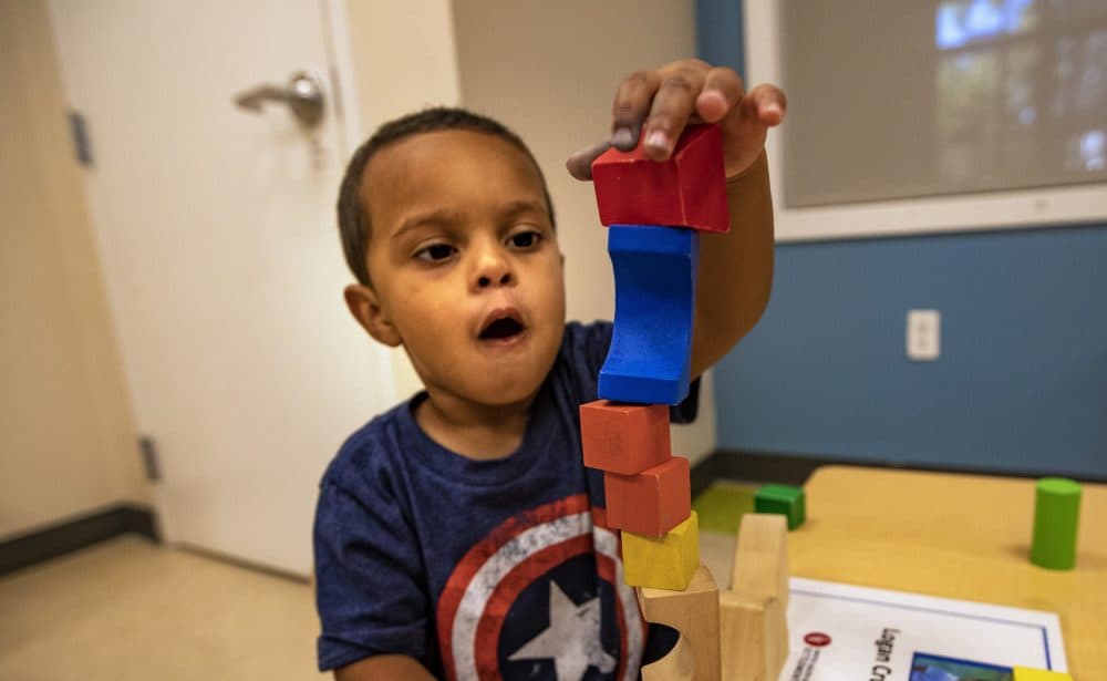 Children in the toddler room at the United South End Settlements summer program do activities such as building with blocks. (Jesse Costa/WBUR)