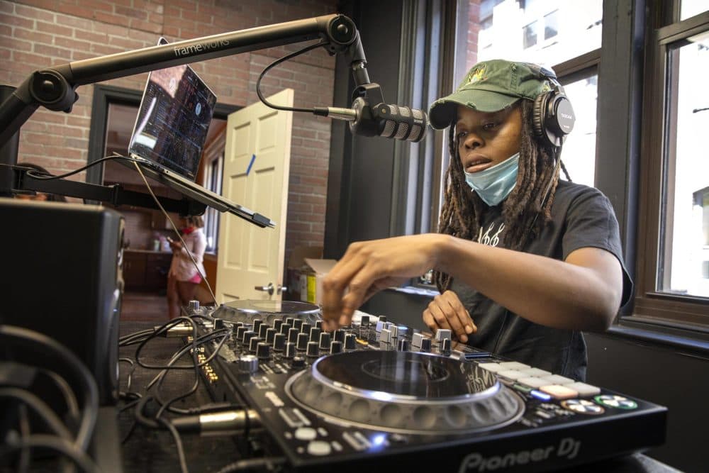 DJ WhySham, Shamara Rhodes, lines up some music for a show on Spark FM Online. (Robin Lubbock/WBUR)