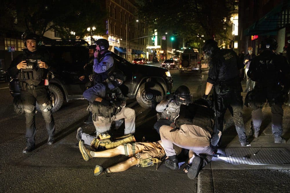 A man is being treated after being shot Saturday, Aug. 29, 2020, in Portland, Ore. Fights broke out in downtown Portland Saturday night as a large caravan of supporters of President Donald Trump drove through the city, clashing with counter-protesters. (Paula Bronstein/AP)
