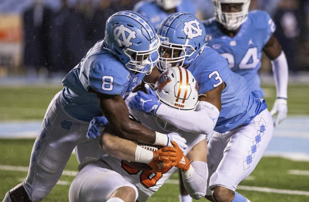 North Carolina's Khadry Jackson (8) and Dominique Ross (3) tackle Mercer's Chris Ellington (88) during the second half of an NCAA college football game in Chapel Hill, N.C., Saturday, Nov. 23, 2019. (Ben McKeown/AP)