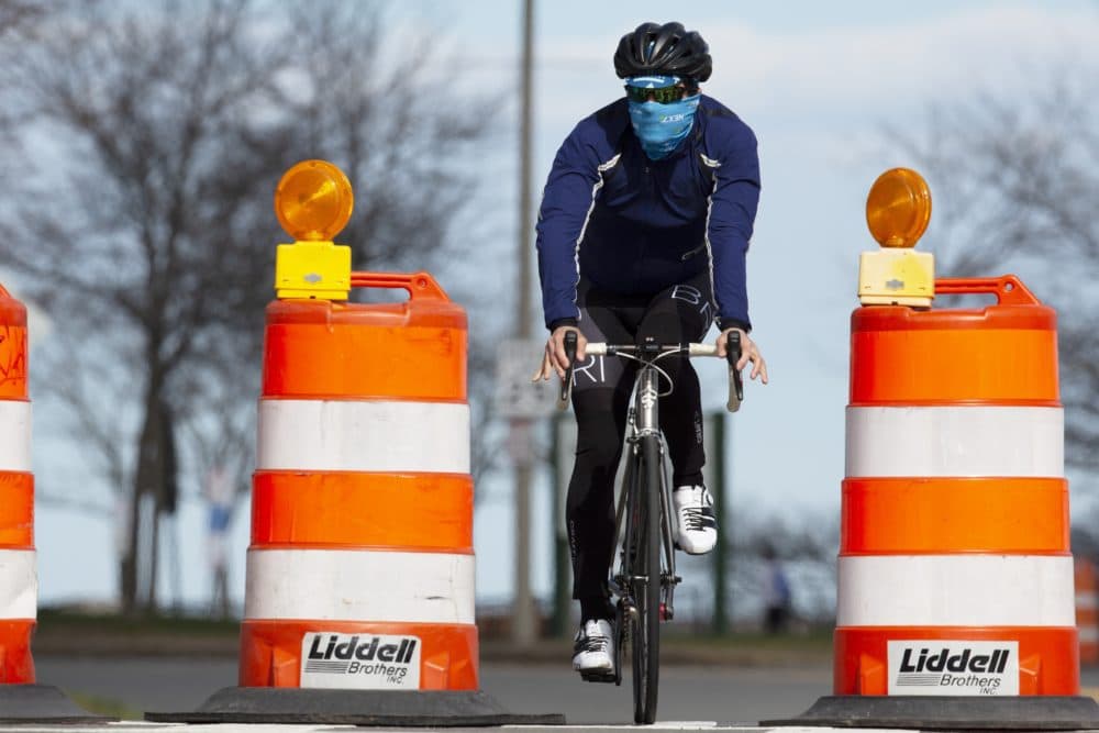 A cyclist rides down Day Boulevard in Boston, which was closed to traffic to allow pedestrians to socially distance, April 2020. (Michael Dwyer/AP)
