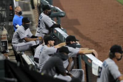 Miami Marlins players watch during the first inning of Tuesday's game in Baltimore. (Julio Cortez/AP)