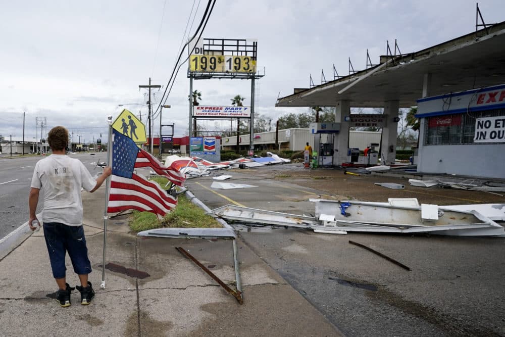 Dustin Amos walks near debris at a gas station on Thursday, Aug. 27, 2020, in Lake Charles, La., after Hurricane Laura moved through the state. (Gerald Herbert/AP)