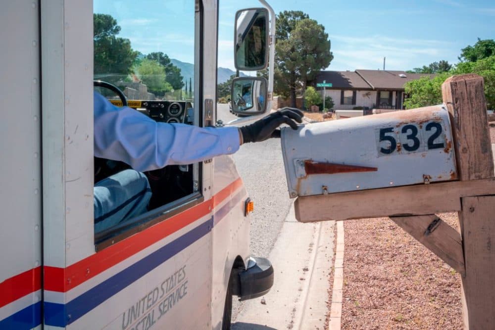 United States Postal Service mail carrier Frank Colon delivers mail amid the coronavirus pandemic in El Paso, Texas. (Paul Ratje/AFP/Getty Images)
