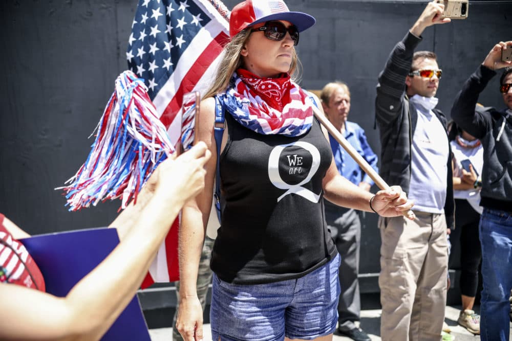 Conspiracy theorist QAnon demonstrators protest during a rally to re-open California and against Stay-At-Home directives on May 1, 2020 in San Diego, California. (Sandy Huffaker/AFP via Getty Images)