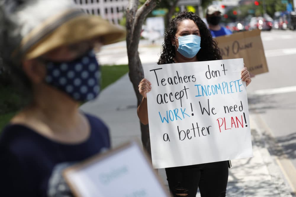 First grade teacher Yolanda Vasquez stands in protest along with other teachers and counselors in front of the Hillsborough County Schools District Office on July 16, 2020 in Tampa, Florida. (Octavio Jones/Getty Images)