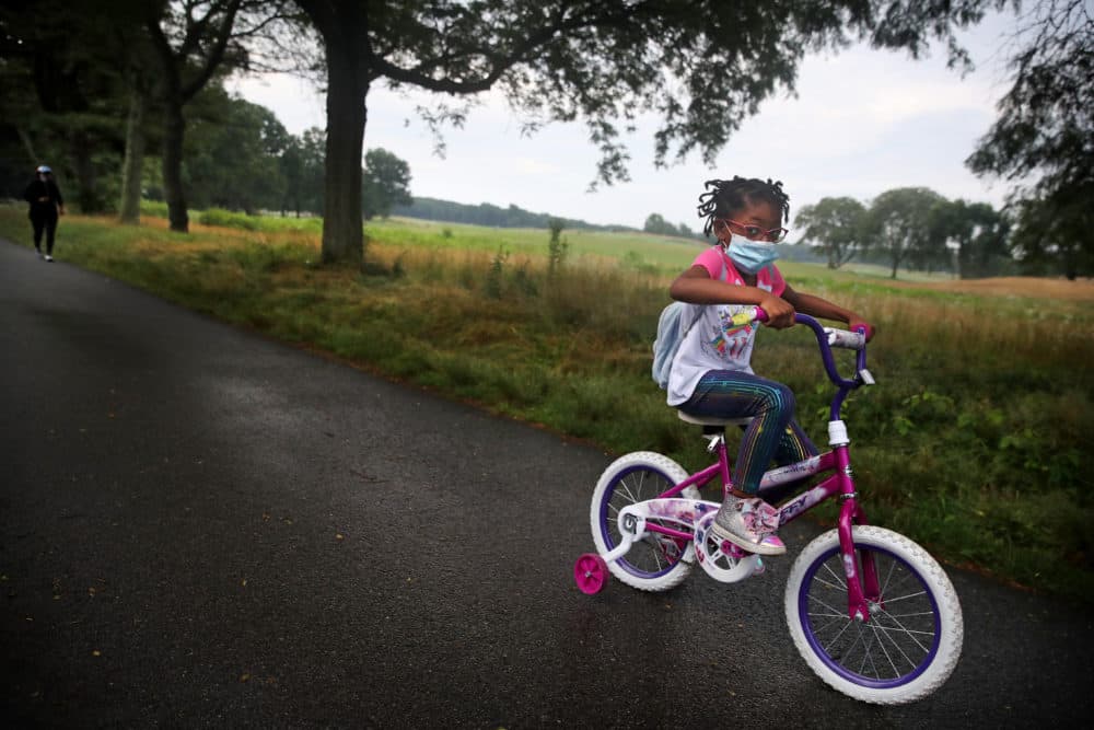 BOSTON - JULY 23: A young girl leads her mother through Franklin Park during their morning exercise routine in Boston, MA on July 23, 2020. (Photo by Craig F. Walker/The Boston Globe via Getty Images)