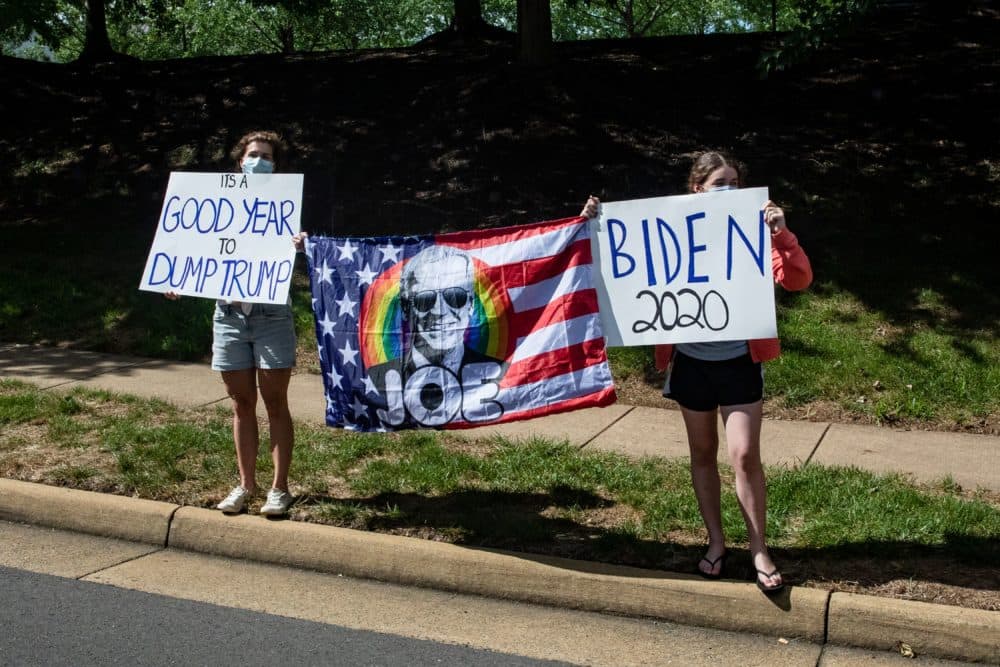 Supporters of Democratic presidential candidate Joe Biden stand along the road as President Trump's motorcade leaves his golf club, Trump National, on August 30, 2020 in Sterling, Virginia. (SAMUEL CORUM/Agence France-Presse/AFP via Getty Images)