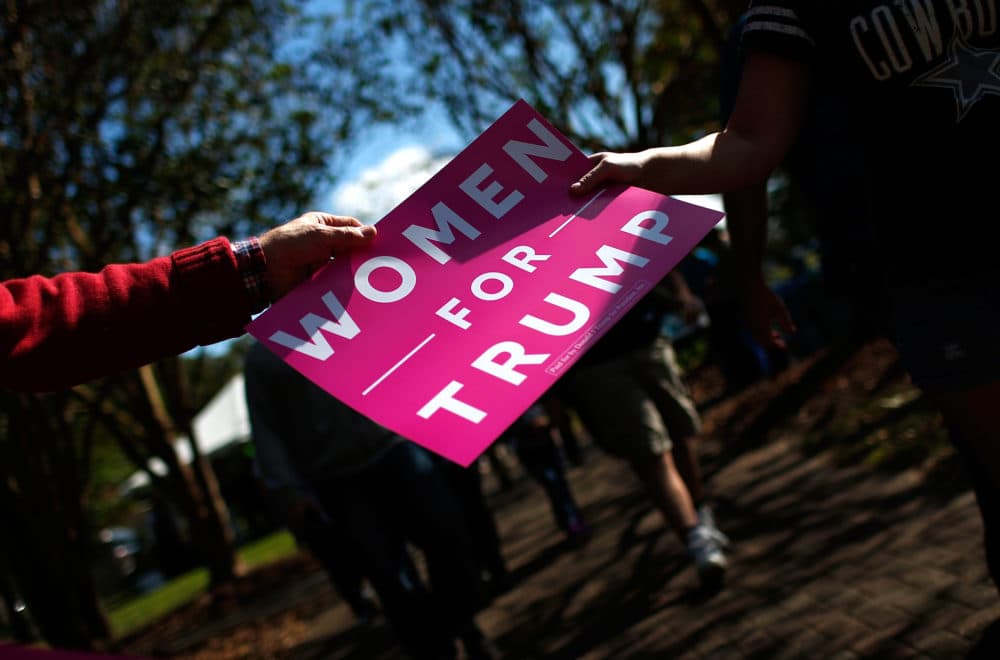Volunteers pass out &quot;Women For Trump&quot; signs before a campaign event featuring then Republican presidential candidate Donald Trump at Regent University Oct. 22, 2016 in Virginia Beach, Virginia. (Win McNamee/Getty Images)