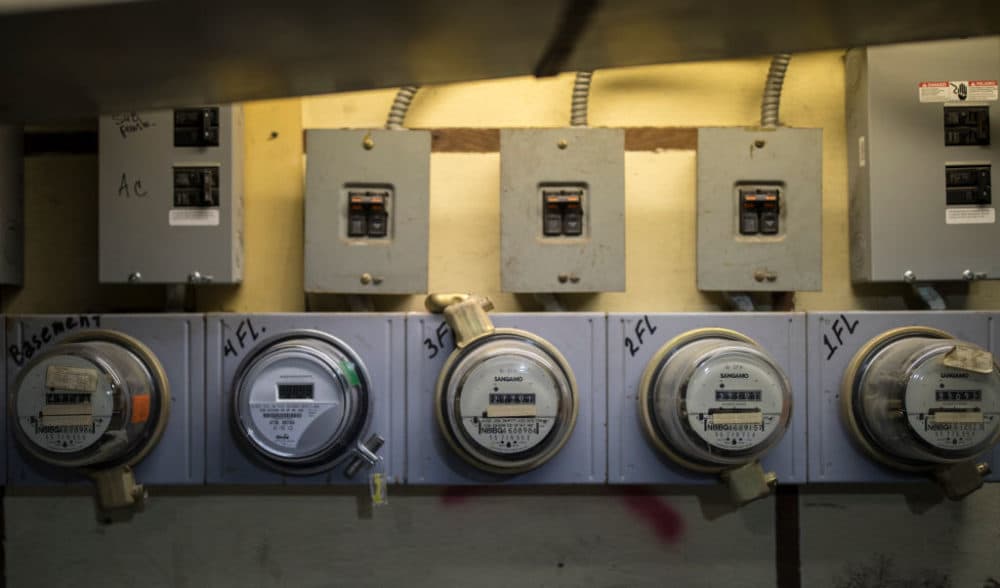 Five electricity meters measure power consumption in an apartment building in Brooklyn, New York. (Robert Nickelsberg/Getty Images)
