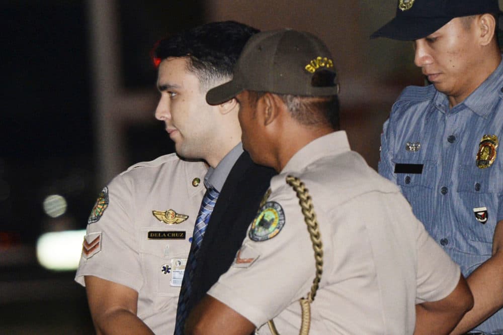 In this Dec. 1, 2015 photo, convicted U.S. Marine Lance Cpl. Joseph Scott Pemberton is escorted to his detention cell upon arrival at Camp Aguinaldo in the Philippines. The Philippine president pardoned the U.S. Marine on Monday in a surprise move that will free him from imprisonment in the 2014 killing of a transgender Filipino woman that sparked anger in the former American colony. (Ted Aljibe/AP Pool Photo)