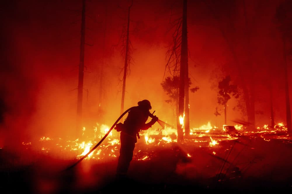 In this Sept. 7, 2020, file photo, a firefighter battles the Creek Fire as it threatens homes in the Cascadel Woods neighborhood of Madera County, Calif. (Noah Berger/AP)