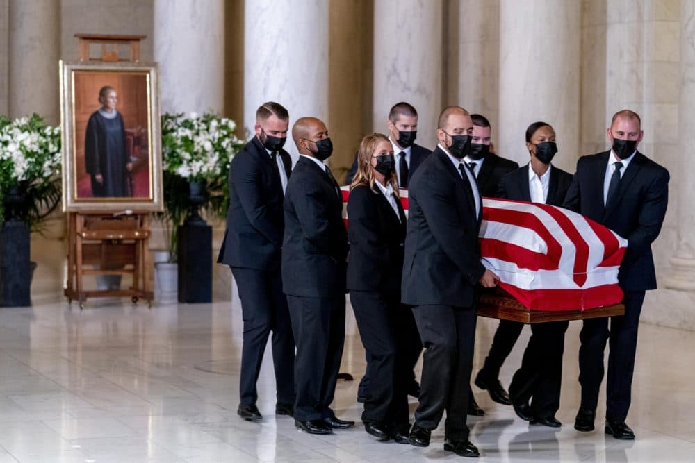 The flag-draped casket of Justice Ruth Bader Ginsburg, carried by Supreme Court police officers, arrived in the Great Hall at the Supreme Court in Washington Wednesday. Ginsburg, 87, died of cancer on Sept. 18. (Andrew Harnik/AP)