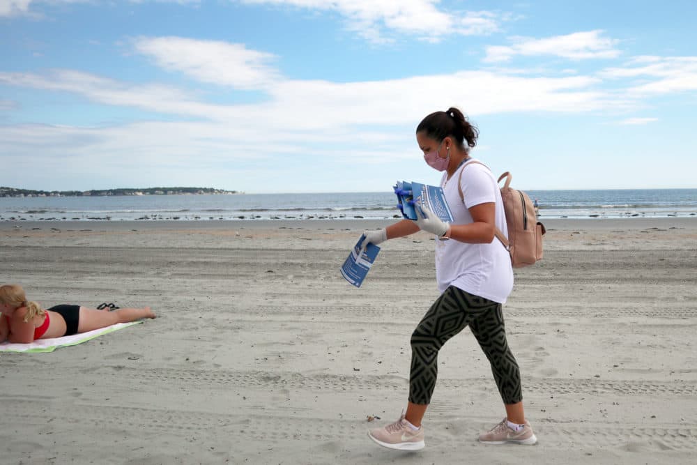 Cristiane Alves hits the beach on Labor Day weekend as part of an effort to spread awareness about COVID-19 prevention in Lynn, which continues to see a higher-than-average number of cases. (Adrian Ma/WBUR)