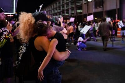 A mother holds her daughter in her arms, on June 1, 2020, in downtown Las Vegas, as she takes part in a Black Lives Matter rally in response to the  death of George Floyd, an unarmed black man who died under the knee of a white Minneapolis police officer. (Bridget Bennett/AFP via Getty Images)