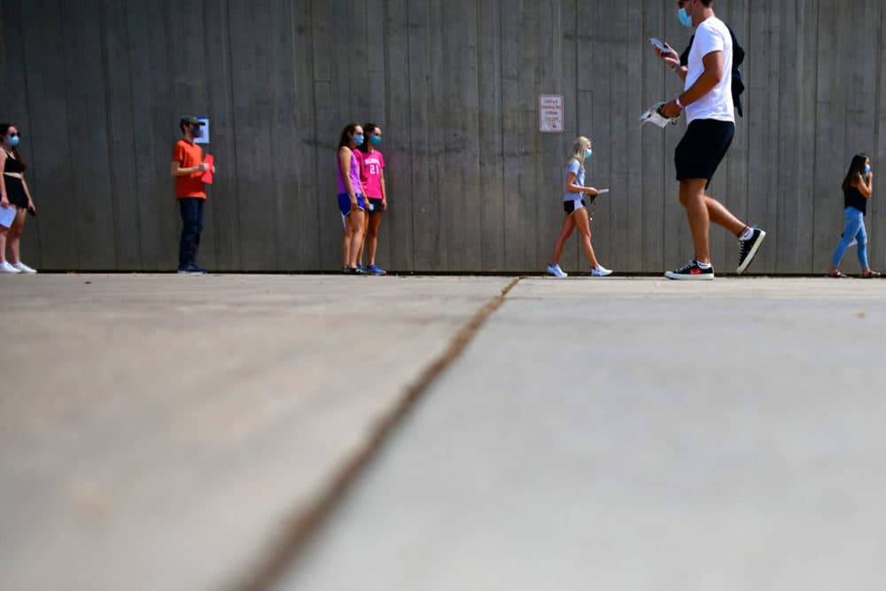 Students wait in line for registration and an identifying wristband after receiving a negative test result for coronavirus while arriving on campus at University of Colorado Boulder on August 18, 2020, in Boulder, Colorado. (Mark Makela/Getty Images)