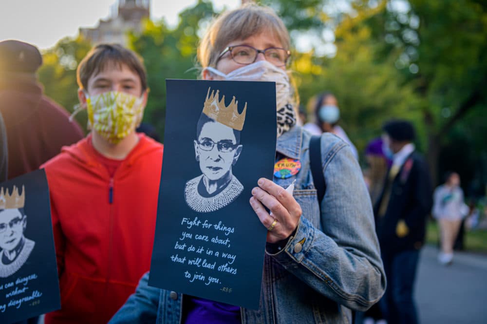 A participant holding a sign at a candle light vigil and memorial for Justice Ruth Bader Ginsburg at  Washington Square Park in New York City on September 19, 2020. (Erik McGregor/LightRocket via Getty Images)