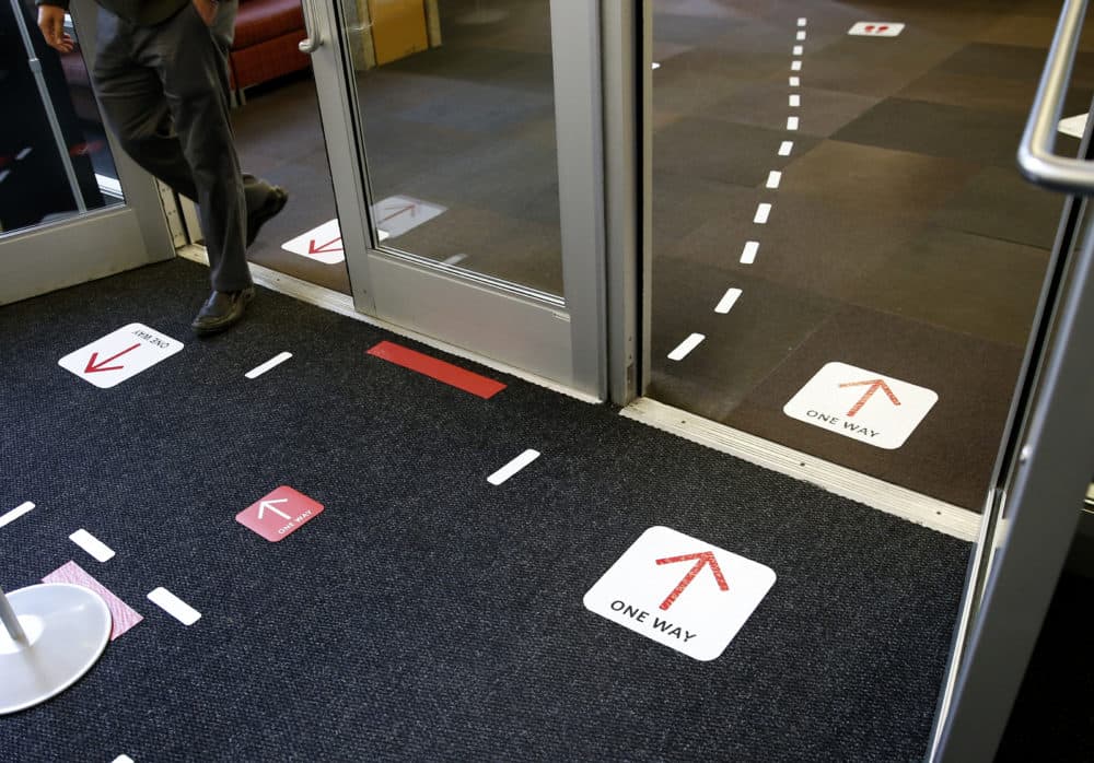 Directions for entering and exiting the library are clearly marked at Boston University in Boston on Sept. 23, 2020. (essica Rinaldi/The Boston Globe via Getty Images)