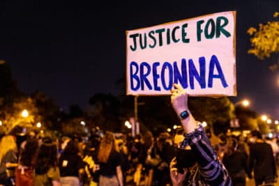 A protester carries a sign in honor of Breonna Taylor on Wednesday in Chicago. (Natasha Moustache/Getty Images)