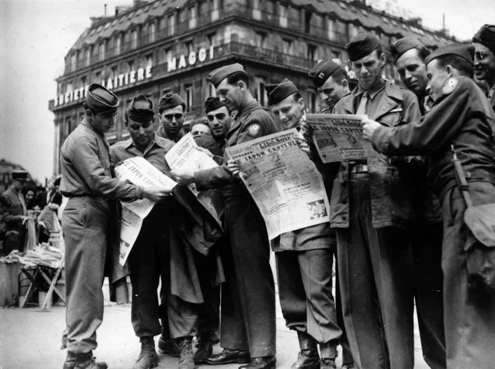American troops at Place de l' Opera read news of the Japanese surrender in the newspaper in August 1945. (Keystone/Getty Images)