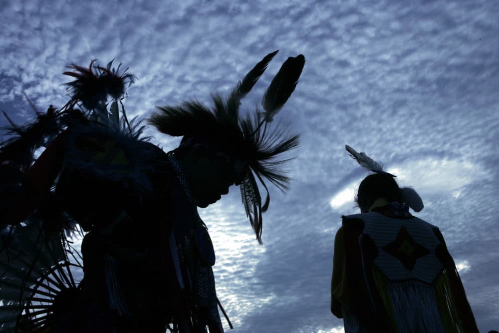 Harrison Revels (L) and his cousin Courtney Baxter, members of the Lumbee Tribe in North Carolina, wait for a tribal dance on the National Mall after the grand opening of the Smithsonian's National Museum of the American Indian in 2004. (Brendan Smialowski/AFP/Getty Images)