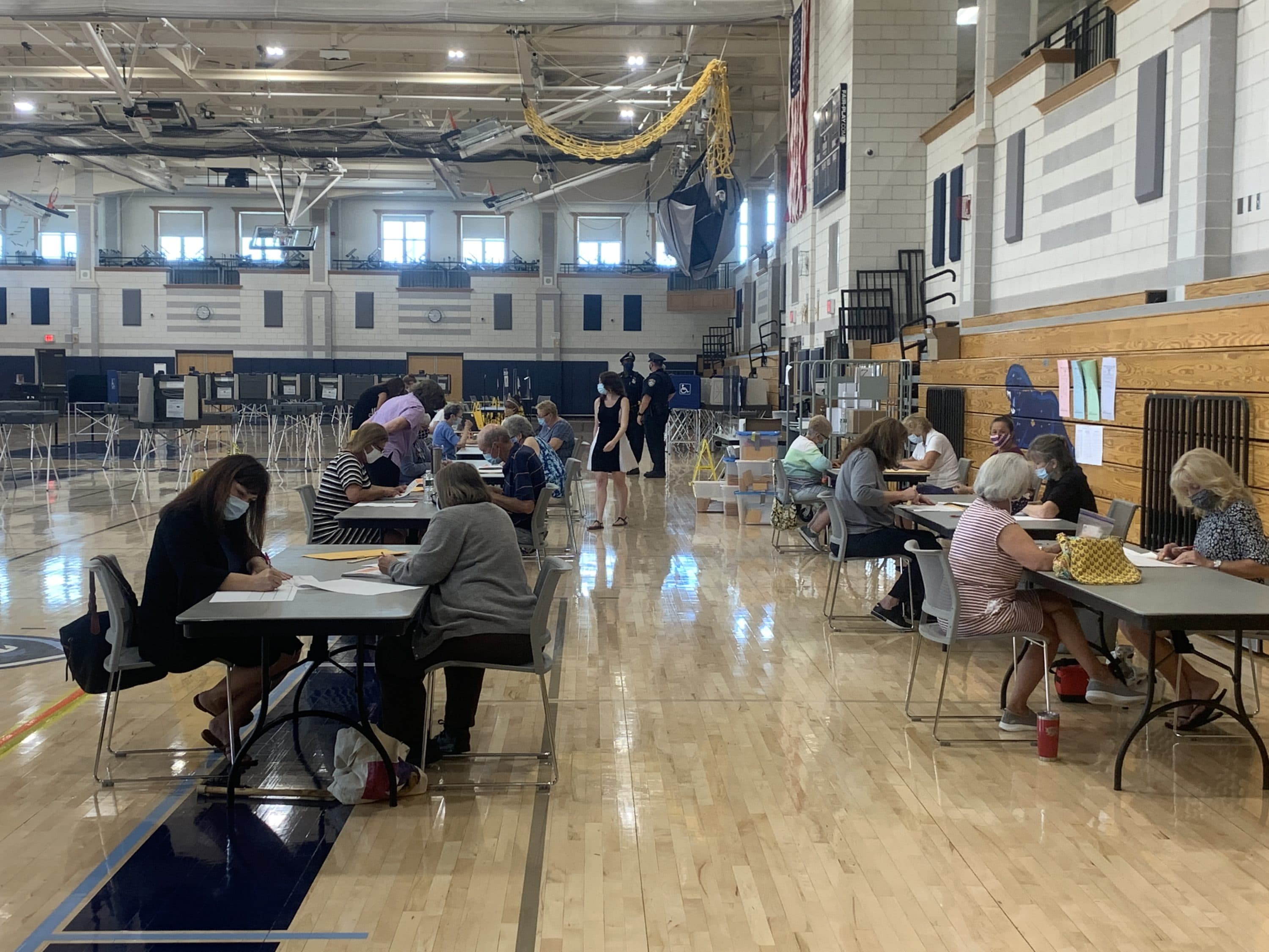 Election workers and staffers from the Secretary of State's office continue to count votes in Franklin, where roughly 3,000 uncounted ballots were discovered two days after Tuesday's primary. (Simón Rios/WBUR)