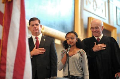 Mayor Martin Walsh and U.S. District Judge Nathaniel Gorton join Soley Guerrero in the Pledge of Allegience during a U.S. Naturalization ceremony July 10, 2014 at Faneuil Hall. (Don Harney/City of Boston)