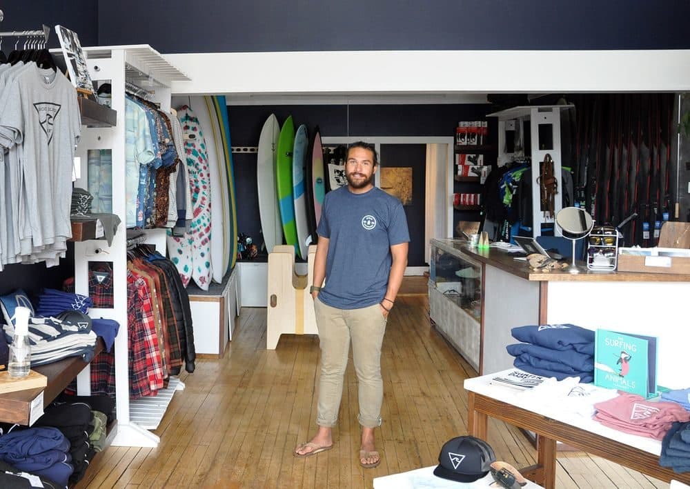 Walle Hutton, owner of Rhode Island Surf Co., at his shop in downtown Westerly. (Alex Nunes/The Public's Radio)