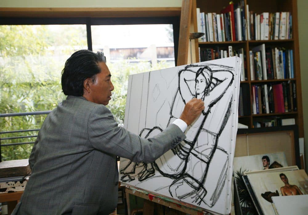 In this Tuesday, March 24, 2009 file photo, Japanese fashion designer Kenzo Takada sketches in his Paris house. Fashion designer Kenzo Takada dies from COVID-19 complications at age 81 near Paris, spokeswoman and reports said Sunday Oct. 4, 2020. (Jacques Brinon/AP)