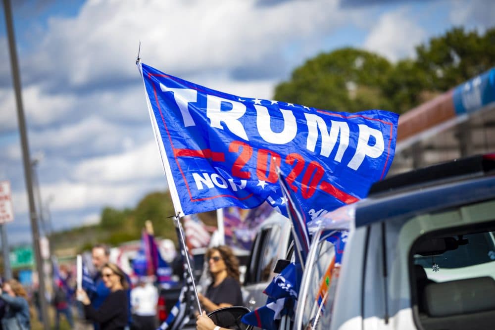 About 150 cars lined up for a 'Trump Train' rally in Londonderry, N.H. on Sunday to express their support for President Trump. But some voters in the key state have mixed feelings about the president and his handling of the coronavirus pandemic. (Jesse Costa/WBUR)