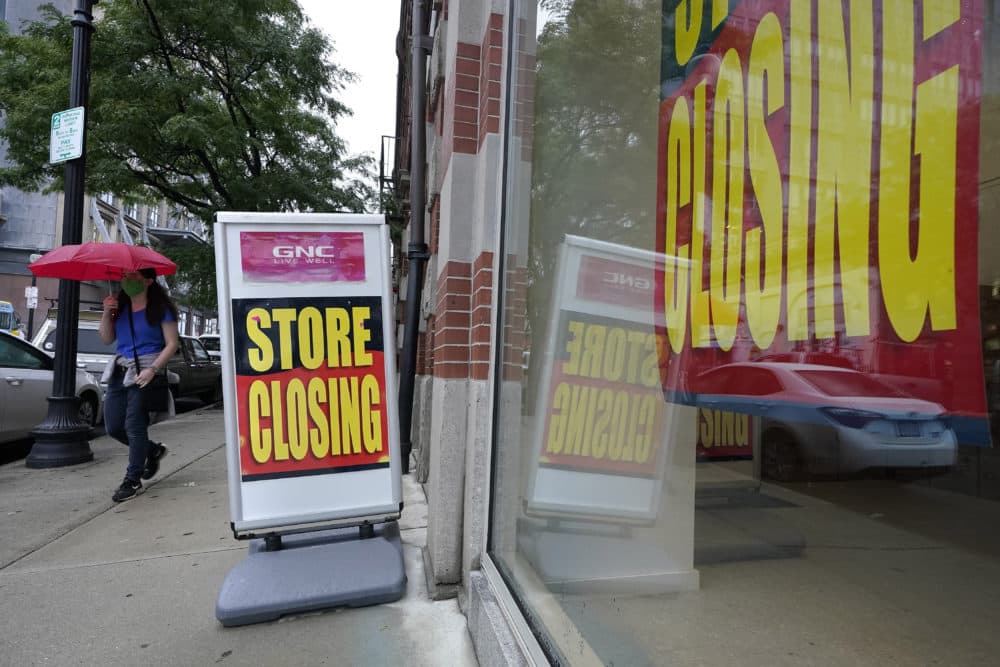In this Sept. 2, 2020, file photo, a passerby walks past a business storefront with store closing signs in Boston. The U.S. unemployment rate dropped to 7.9% in September, but hiring is slowing and many Americans have given up looking for work, the government said Friday, Oct. 2, in the final jobs report before the voters decide whether to give President Donald Trump another term. (AP Photo/Steven Senne)